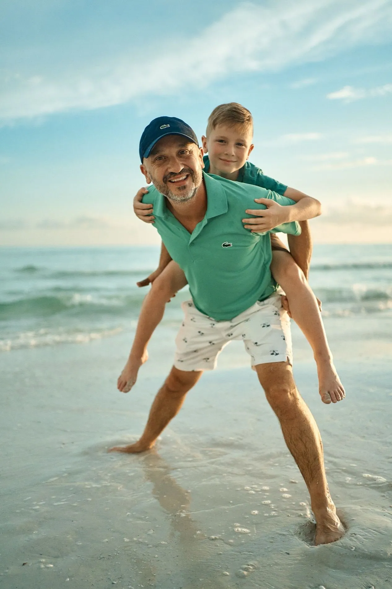 A father and son walking together on the beach
