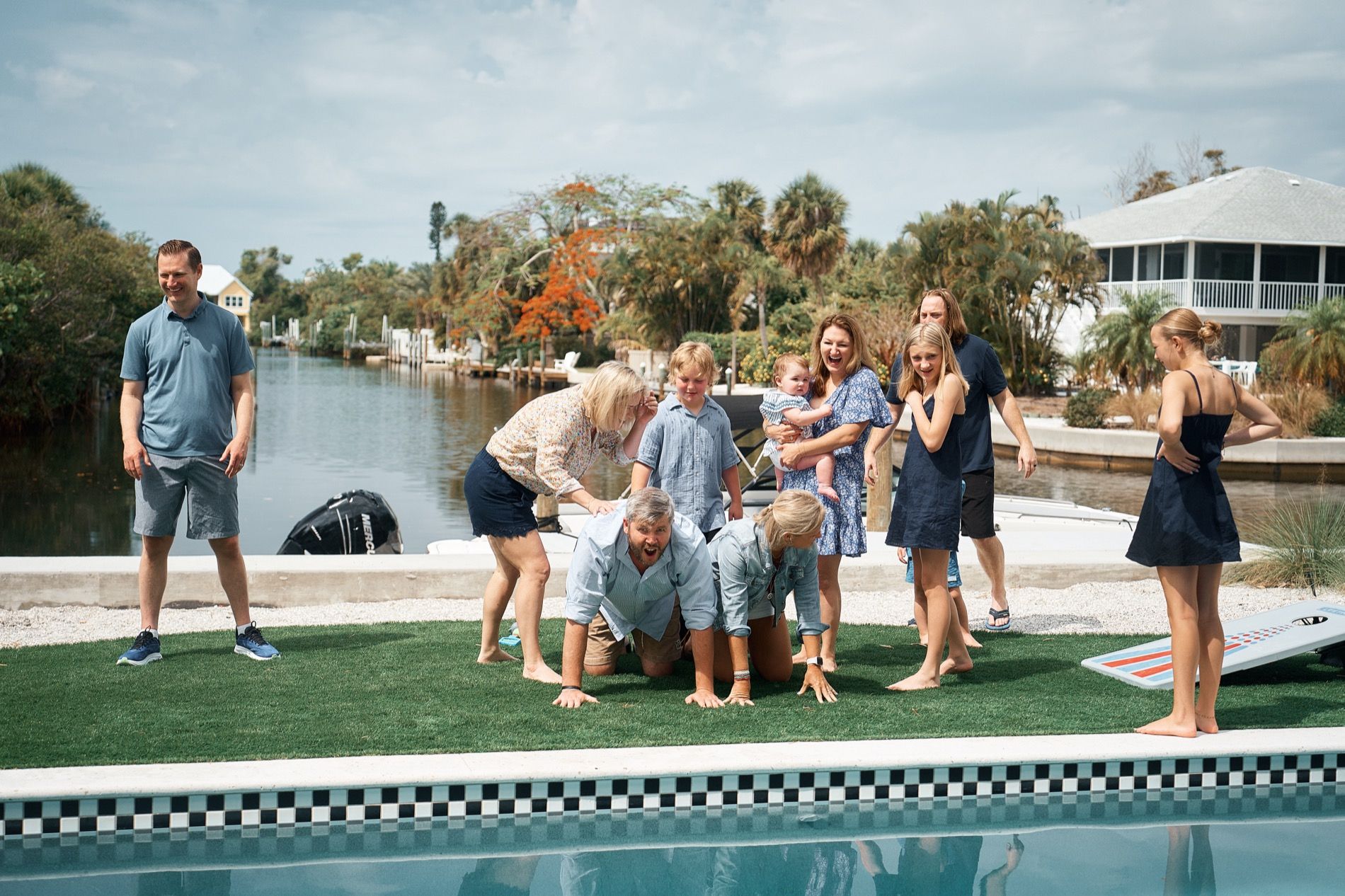 A family playing by the pool of their vacation rental in Sarasota