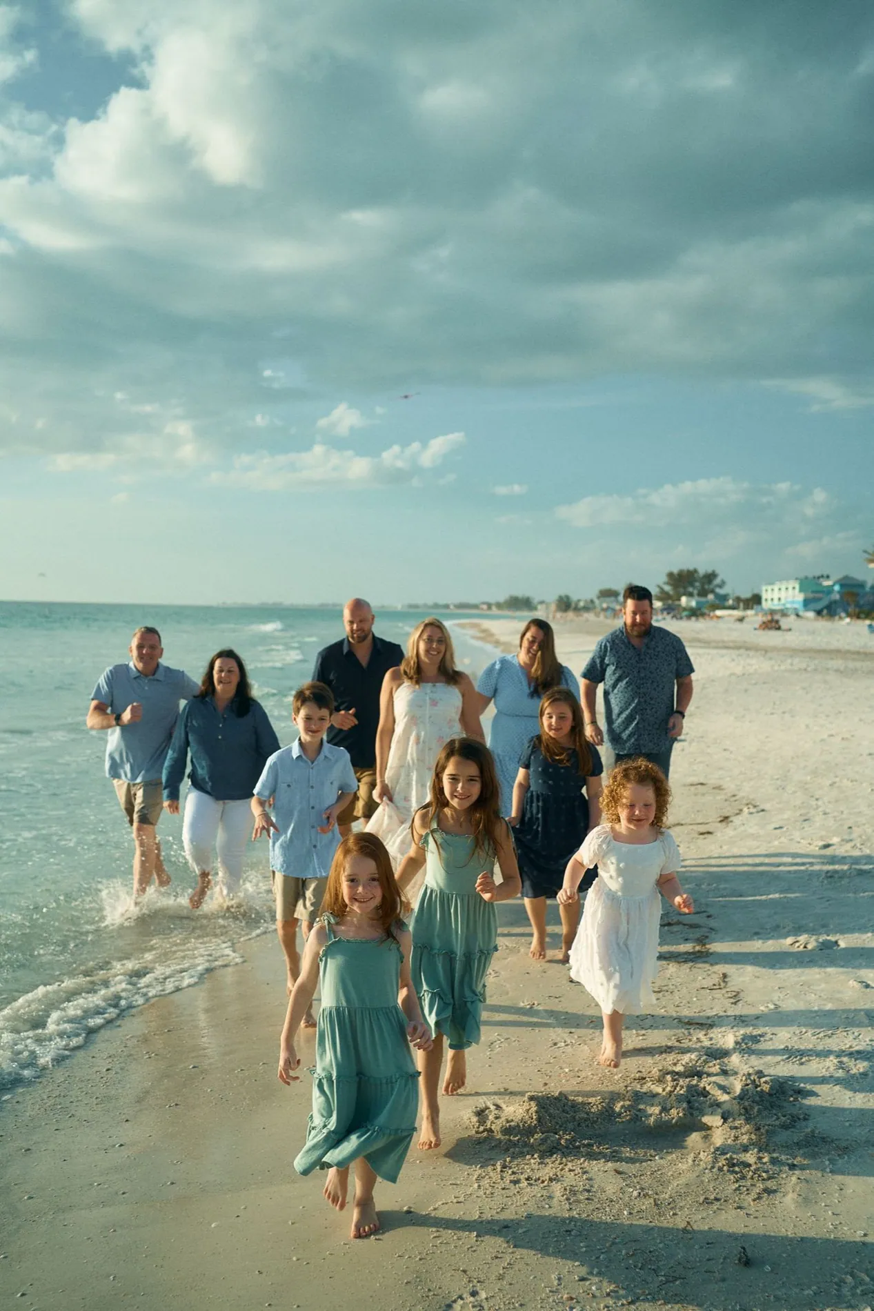 A large family group walking together along the beach