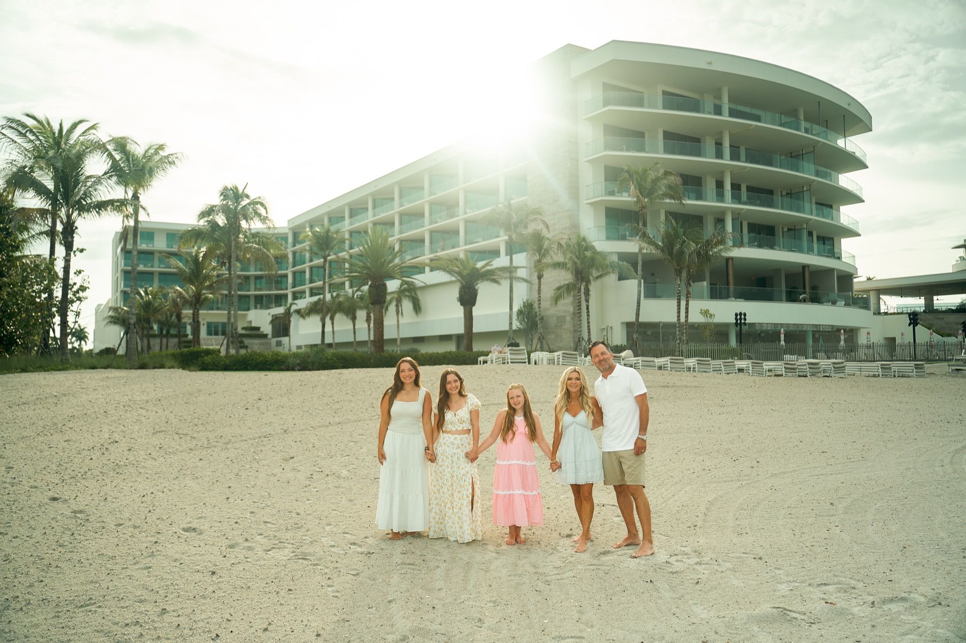 A family on the beach in front of their resort on Longboat Key