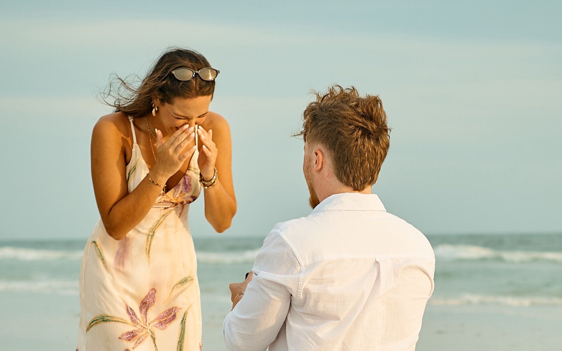 A surprise proposal on a Sarasota beach, the moment she sees the ring