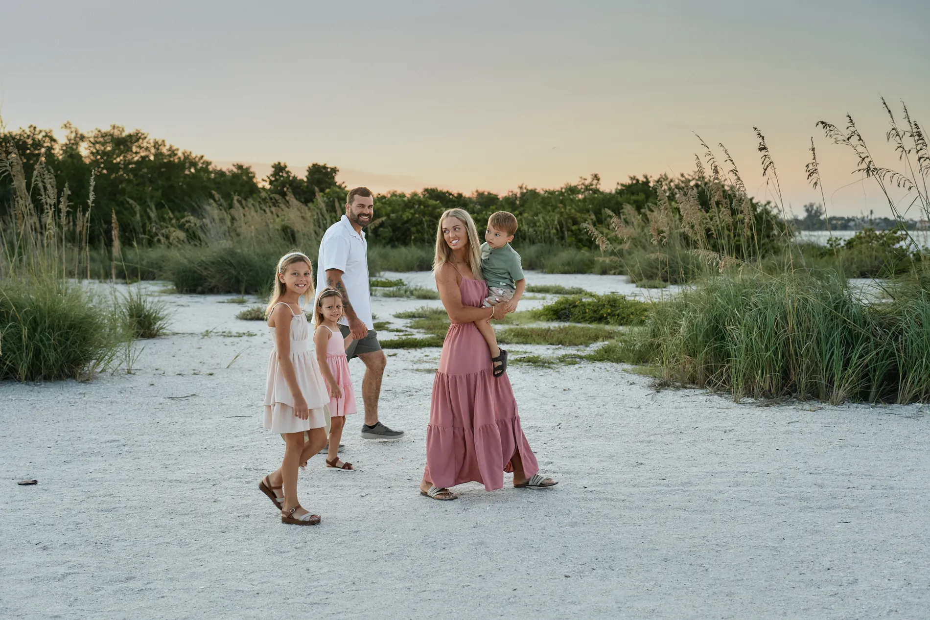 A family among the sea oats on the dunes at South Lido