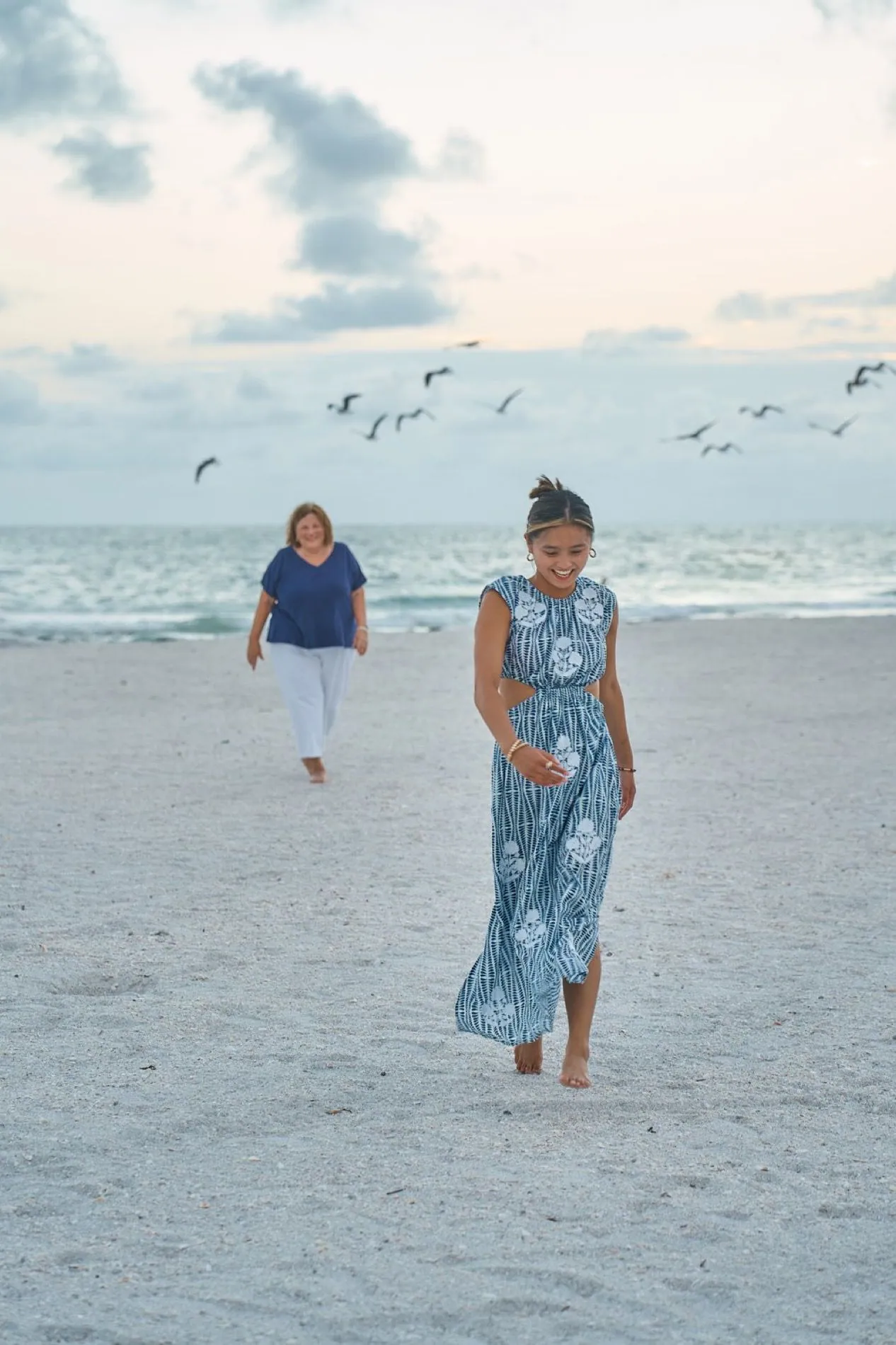 A mother and daughter walking the sand on Lido Key in Sarasota